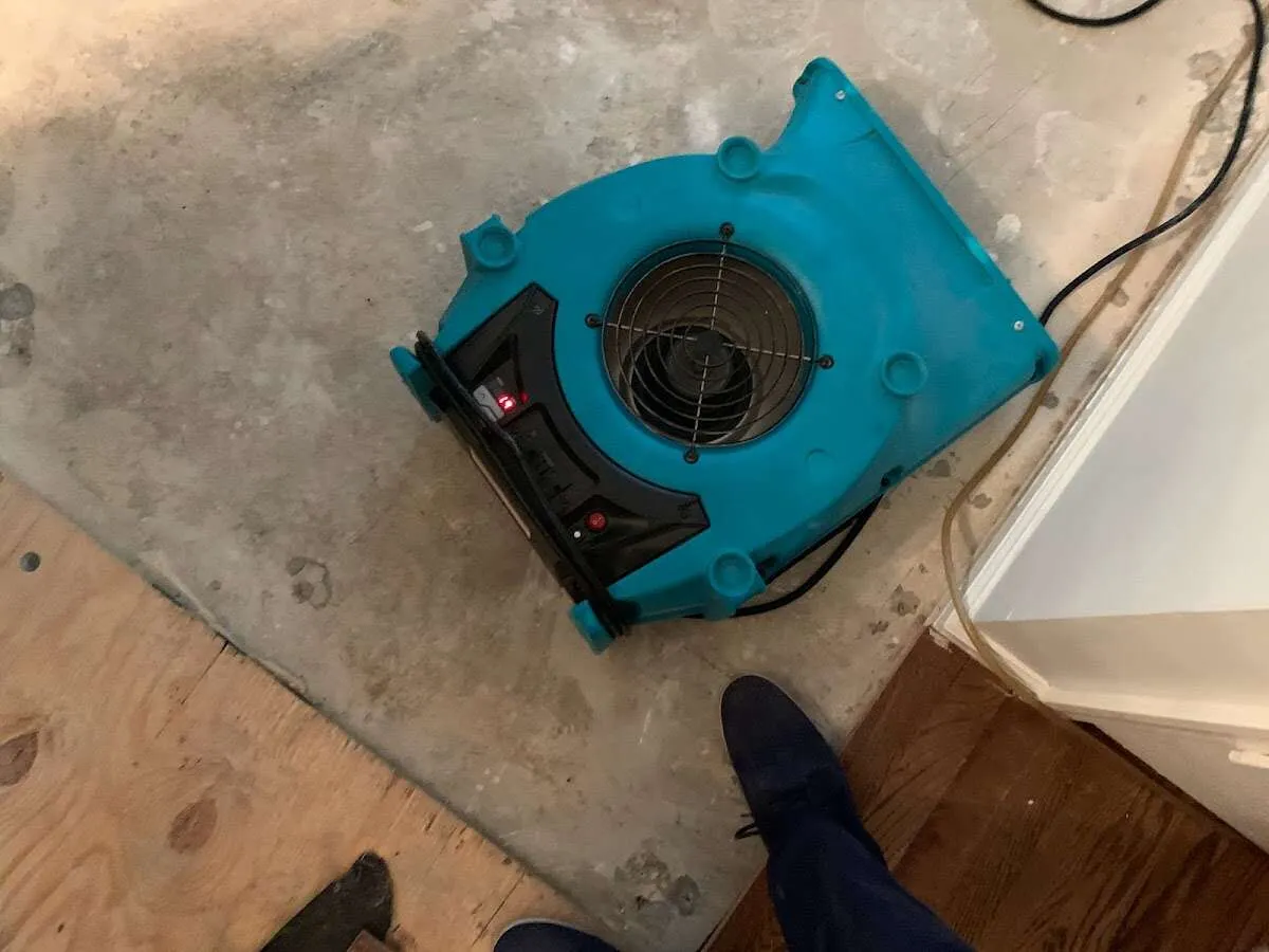 Air mover drying subfloor during Commercial Water Damage Restoration in Hawthorn Woods